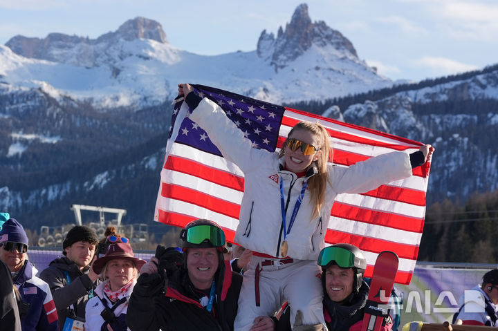 [코르티나담페초=AP/뉴시스] 미케일라 시프린(미국)이 18일(한국 시간) 이탈리아 코르티나담페초의 토파네 알파인스키 센터에서 열린 2026 밀라노·코르티나담페초 동계올림픽 알파인스키 여자 회전에서 금메달을 딴 뒤 팀원들과 함께 기뻐하고 있다. 2026.02.18.