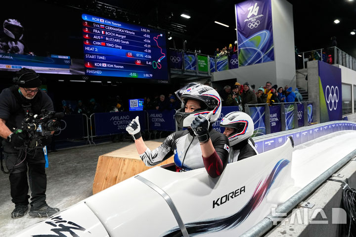 [코르티나담페초=AP/뉴시스] 김유란(앞)과 전은지가 21일(한국 시간) 이탈리아 코르티나담페초의 코르티나 슬라이딩 센터에서 열린 2026 밀라노·코르티나담페초 동계올림픽 봅슬레이 여자 2인승 경기를 마친 뒤 기뻐하고 있다. 2026.02.21.