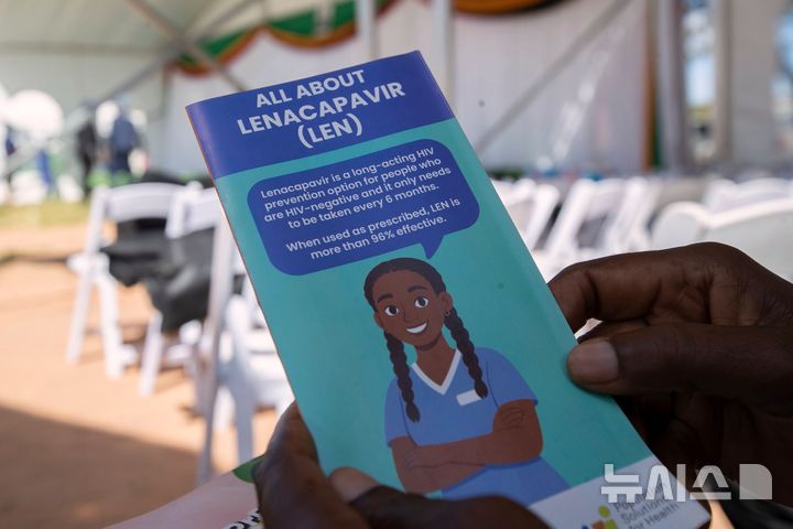 [AP/뉴시스] 짐바브웨 수도 하라레에서 19일 한 여성이 새 인간면역결핍 바이러스(HIV) 예방약인 레나카파비르 설명문을 읽고 있다