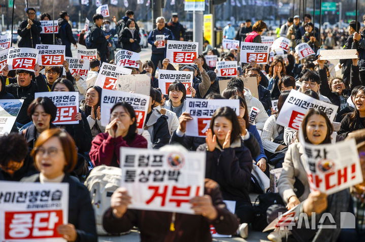 [서울=뉴시스] 정병혁 기자 = 28일 서울 종로구 동십자각 앞에서 열린 '한미전쟁연습 중단! 트럼프 통상압박 안보위협 거부! 시민행진'에서 참가자들이 피켓을 들고 있다. 2026.02.28. jhope@newsis.com