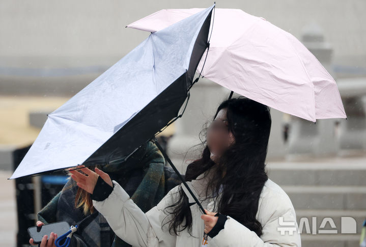 [서울=뉴시스] 추상철 기자 = 강풍을 동반한 비가 내린 2일 오전 서울 종로구 광화문에서 시민의 우산이 뒤짚어 지고 있다. 2026.03.02. scchoo@newsis.com