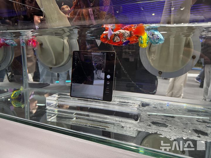 [바르셀로나(스페인)=뉴시스]MWC 2026 행사장에 전시된 아너의 폴더블폰 '아너 V8'의 모습. 방수 및 내구성을 강조하기 위해 기기를 물 속에 넣어둔 채 전시하고 있다. (사진=심지혜 기자)