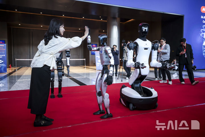 [서울=뉴시스] 정병혁 기자 = 4일 서울 강남구 코엑스에서 열린 2026 스마트공장·자동화산업전에서 직원이 유니트리의 휴머노이드 로봇 G1과 인사를 나누고 있다. 2026.03.04. jhope@newsis.com