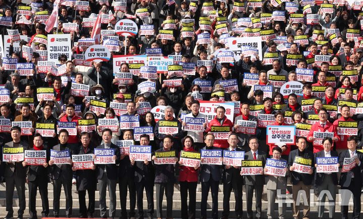 [서울=뉴시스] 조성봉 기자 = 이철우 경북도지사와 국민의힘 의원들을 비롯한 참석자들이 4일 오후 서울 여의도 국회 본청 계단에서 열린 '대구경북행정통합특별법 통과 촉구 대구경북 결의대회'에서 손피켓을 들고 구호를 외치고 있다. 2026.03.04. suncho21@newsis.com