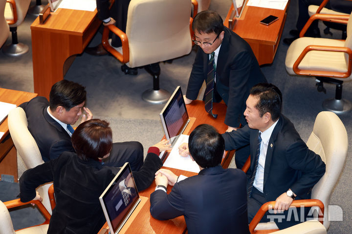 [서울=뉴시스] 고승민 기자 = 더불어민주당 정청래 대표와 한병도 원내대표 등 의원들이 12일 서울 여의도 국회에서 열린 제433회 국회(임시회) 제1차 본회의에서 대화하고 있다. 2026.03.12. kkssmm99@newsis.com