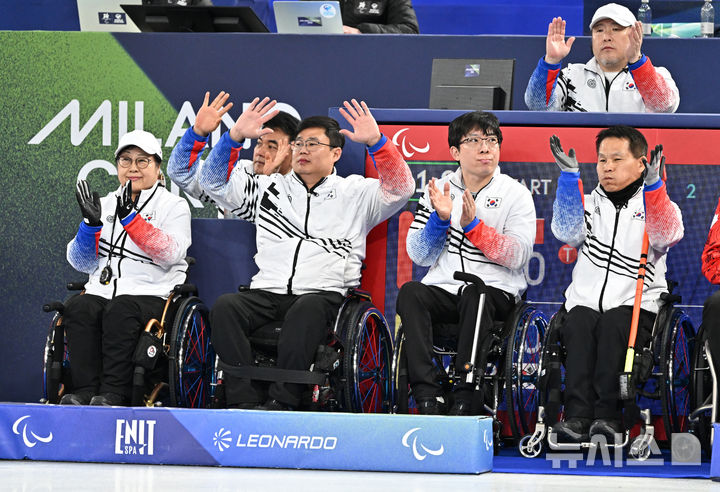 [코르티나담페초=뉴시스] 사진공동취재단 = 휠체어컬링 방민자(왼쪽부터), 이현출, 남봉광, 양희태가 12일(현지 시간) 이탈리아 코르티나담페초 컬링 올림픽 스타디움에서 열린 2026 밀라노 코르티나 패럴림픽 휠체어컬링 혼성 4인조 캐나다와의 예선전에 앞서 관중들에게 인사를 하고 있다. 2026.03.12. photo@newsis.com