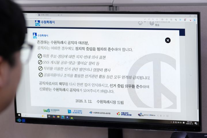 [수원=뉴시스] 수원시 공직자들이 행정포털 로그인 화면에 게시된 '선거중립의무 준수' 안내 팝업을 확인하고 있다.. (사진=수원시 제공) 2026.03.13 photo@newsis.com *재판매 및 DB 금지