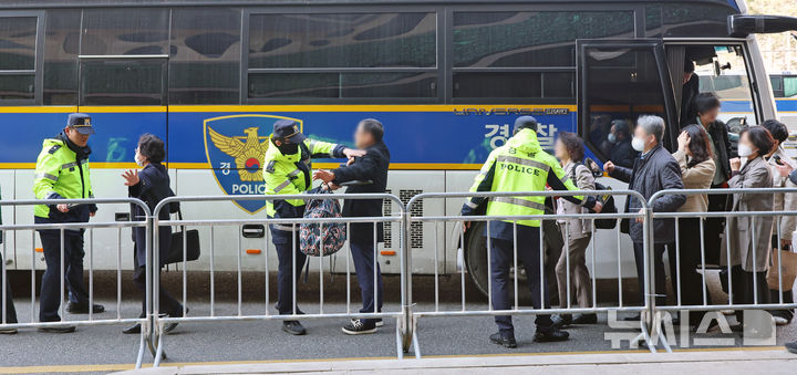 [서울=뉴시스] 조성우 기자 = 그룹 방탄소년단(BTS) 컴백 공연이 열리는 21일 오후 서울 중구 서울광장 인근에서 공연장 주변 결혼식 하객들이 경찰 기동대 버스에서 내려 핸드스캐너 검사를 받고 있다. 서울경찰청은 이날 오후 3시부터 4시까지 을지로3가역~한국프레스센터 구간에 기동대 버스를 투입해 하객 이동을 지원한다고 밝혔다. 2026.03.21. xconfind@newsis.com
