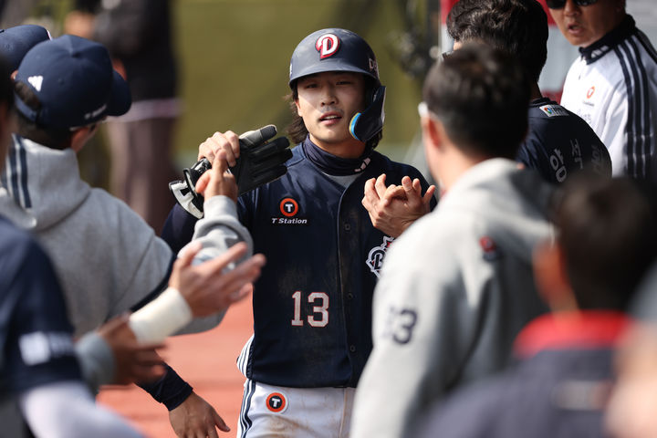 [서울=뉴시스] 프로야구 두산 베어스 이유찬이 23일 수원 KT위즈파크에서 열린 2026 신한 쏠 KBO리그 KT 위즈와의 시범경기에서 득점을 올린 뒤 동료들의 축하를 받고 있다. (사진=두산 베어스 제공) 2026.03.23. *재판매 및 DB 금지