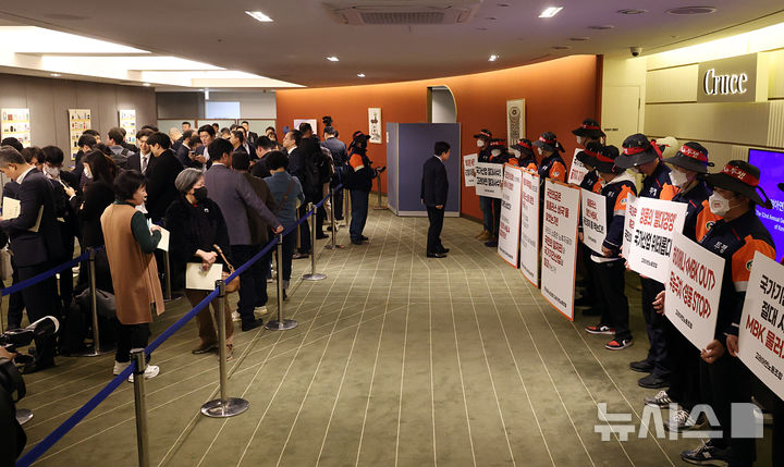 [서울=뉴시스] 최진석 기자 = 24일 오전 서울 중구 코리아나호텔 제 52기 고려아연 정기 주주총회주총장 입구에서 고려아연노조원들이 입장을 기다리는 주주들 바라보며 피켓을 들고 있다. (공동취재) 2026.03.24. photo@newsis.com