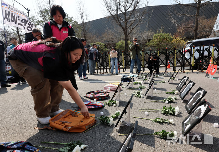 [서울=뉴시스] 배훈식 기자 = 전국민주노동조합총연맹 조합원들이 25일 오후 서울 종로구 청와대 사랑채 인근에서 열린 미국·이스라엘 침략전쟁 규탄! 파병 반대! 결의대회에서 이란 초등학교 폭격 희생자 영정에 헌화하고 있다. 2026.03.25. dahora83@newsis.com