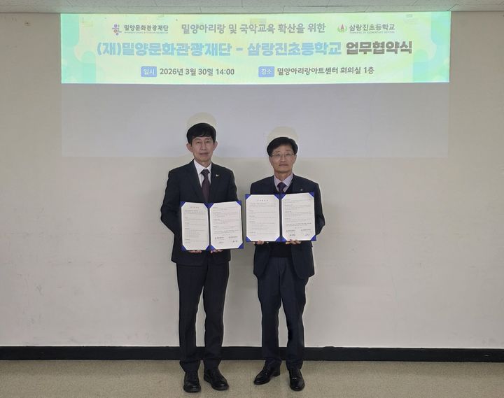 [밀양=뉴시스] 밀양문화관광재단 이치우(왼쪽) 대표와 권오환 삼랑진초등학교 교장이 밀양아리랑 전승 기반 강화 및 국악 교육 진흥을 위한 업무 협약체결을 하고 있다. (사진=밀양시 제공) 2026.03.30. photo@newsis.com *재판매 및 DB 금지