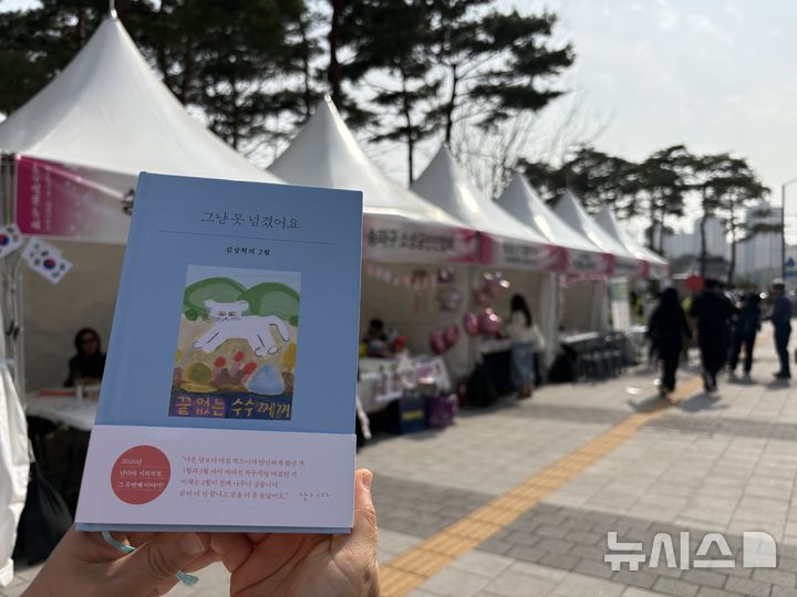 [서울=뉴시스] 한이재 기자 = 3일 오후 서울 송파구 석촌호수 인근 '벚꽃난다詩사랑약국'에서 만난 서혜지(47)씨는 '반려책'으로 김상혁 시인의 에세이 '그냥 못 넘겼어요'를 챙겨 다닌다고 했다. 2026.04.03. nowone@newsis.com