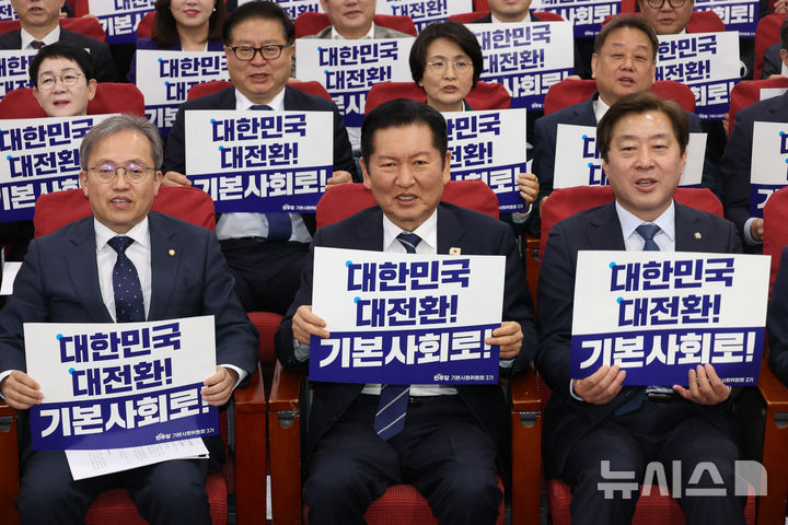 [서울=뉴시스] 고승민 기자 = 정청래 더불어민주당 대표가 7일 서울 여의도 국회 의원회관에서 열린 기본사회위원회 3기 출범식에서 송기헌 의원 등 참석자들과 피켓을 들고 기념촬영하고 있다. 2026.04.07. kkssmm99@newsis.com