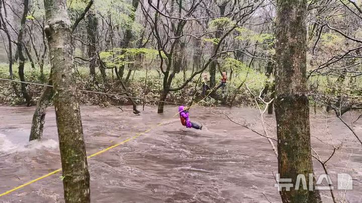 [제주=뉴시스] 강풍경보와 호우경보가 발효 중인 9일 오후 제주시 조천읍 교래리 소재 숲길에서 탐방객들이 불어난 하천에 고립돼 소방당국이 구조에 나서고 있다. (사진=제주소방안전본부 제공) 2026.04.09. photo@newsis.com