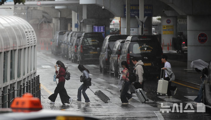 [제주=뉴시스] 우장호 기자 = 제주지역 기상이 악화한 9일 오전 제주국제공항 1층 도착장에서 이용객들이 비를 피해 달려가고 있다. 2026.04.09. woo1223@newsis.com