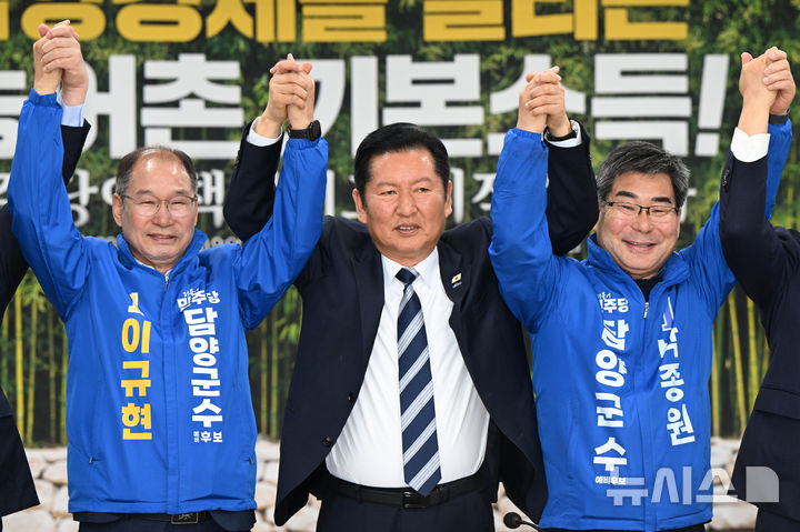 [담양=뉴시스] 박기웅 기자 = 정청래 더불어민주당 대표가 10일 오전 전남 담양군 담양농협에서 열린 현장 최고위원회의에서 민주당 담양군수 예비후보들의 손을 들어올리고 있다. 2026.04.10. pboxer@newsis.com