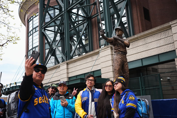 [시애틀=AP/뉴시스] MLB 시애틀 매리너스 팬들이 10일(현지 시간) 미국 워싱턴주 시애틀의 T-모바일 파크 스즈키 이치로 동상 앞에서 기념촬영하고 있다. 2026.04.11