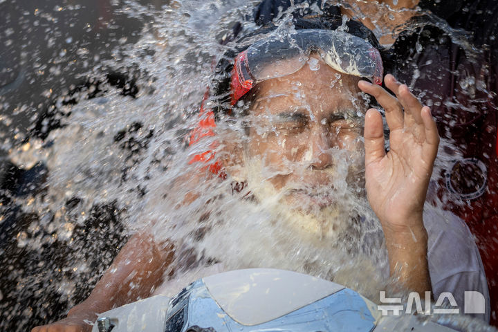 [쁘라친부리=AP/뉴시스] 13일(현지 시간) 태국 쁘라친부리에서 태국 새해를 기념해 열린 송크란 물 축제 기간에 참가한 참가자들이 물세례를 맞고 있다. 2026.04.14.