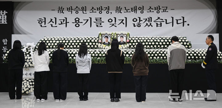 [완도=뉴시스] 이현행 기자 = 완도고등학교 학생들이 13일 오후 전남 완도군 완도문화예술의전당에 마련된 화재 진압 순직 소방관 2명의 합동분향소에서 묵념하고 있다. 2026.04.13. lhh@newsis.com