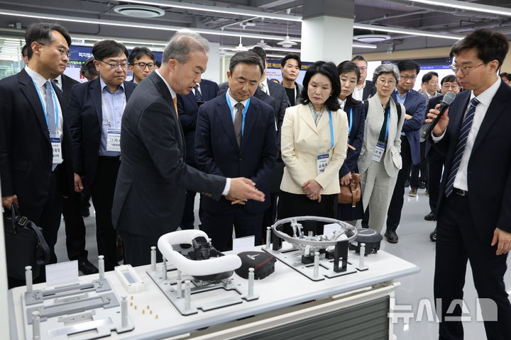 [서울=뉴시스]임문영 상근부위원장이 15일 전북대학교를 방문해 ‘피지컬AI 사전검증(PoC)사업’ 성과점검을 하고 본사업계획을 보고받은 후 제조기술 실증랩을 참관하고 있다. (사진=국가AI전략위원회 제공)