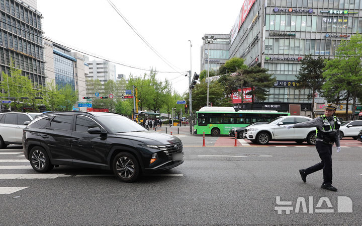[서울=뉴시스] 황준선 기자 = 20일 서울 강남구 대치역 사거리에서 경찰이 우회전 통행 방법 위반 차량에 대한 집중 단속을 하고 있다.경찰청은 지난 2023년 도입된 우회전 일시정지 제도를 현장에 안착시켜 우회전 사고에 취약한 보행자 안전을 확보하기 위해 이날부터 오는 6월 19일까지 2개월간 우회전 통행방법 위반에 대해 집중단속을 실시한다고 밝혔다. 2026.04.20. hwang@newsis.com