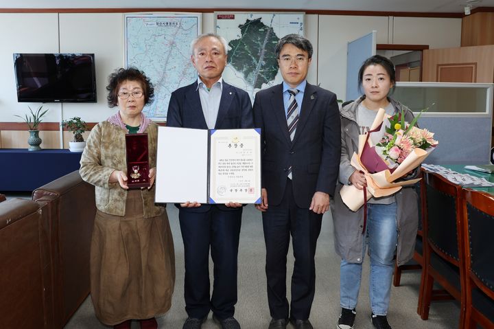 [양산=뉴시스] 김신호 시장 권한대행이 고 권오수 하사의 자녀 권용득씨에게 국방부장관을 대신해 훈장증과 화랑무공훈장을 전수하고 있다. (사진=양산시 제공) 2026.04.21. photo@newsis.com *재판매 및 DB 금지