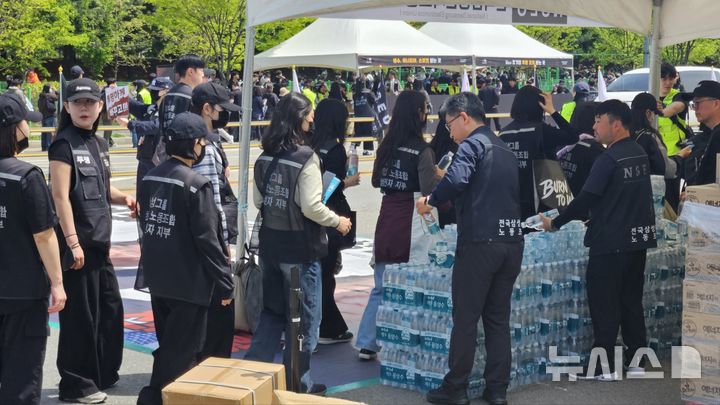 [평택=뉴시스] 노조 관계자들이 결의대회에 참석한 조합원들에게 물품을 나눠주고 있다. 2026.04.23. newswith01@newsis.com 