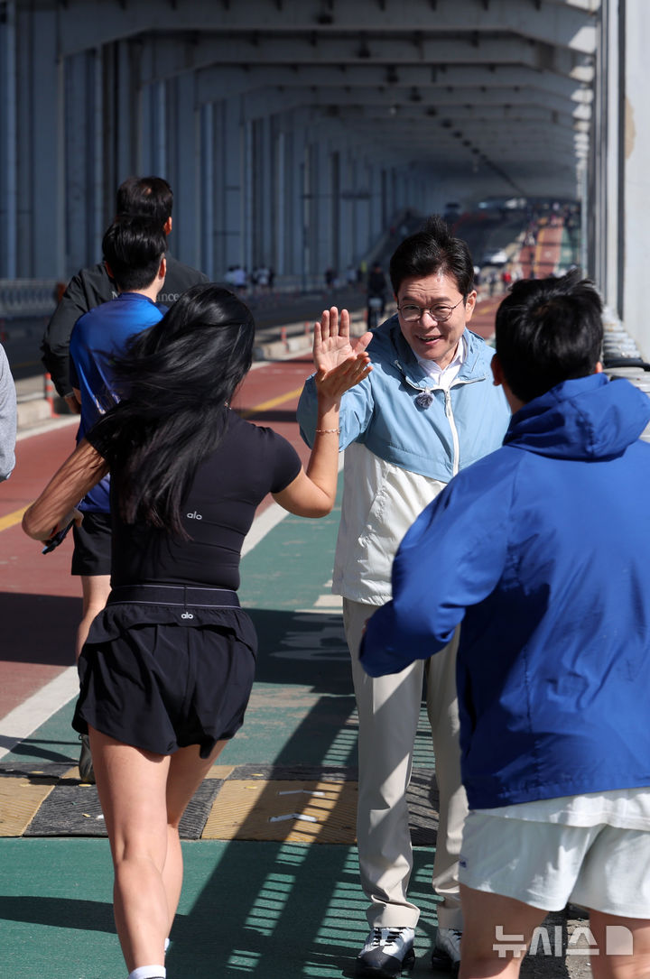 [서울=뉴시스] 이영환 기자 = 정원오 더불어민주당 서울시장 후보가 25일 오전 서울 서초구 잠수교 남단에서 열린 찾아가는 현장 : 러닝편에 참석해 러너들을 격려하고 있다. 2026.04.25. 20hwan@newsis.com