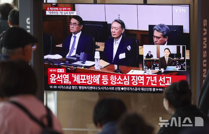 [서울=뉴시스] 조성우 기자 = 29일 오후 서울 중구 서울역 대합실에서 시민들이 체포 방해 및 국무위원 심의권 침해 혐의로 기소된 윤석열 전 대통령에 대한 2심 선고 공판 생중계를 보고 있다. 2026.04.29. xconfind@newsis.com