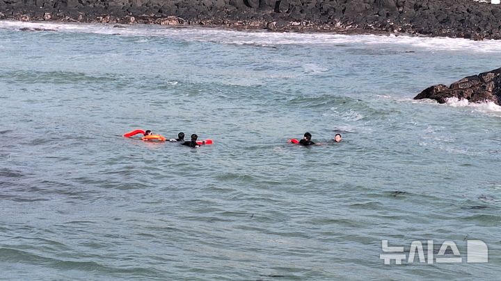 [제주=뉴시스] 4일 오후 제주시 한경면 소재 해안가에서 소방당국이 20대 요구조자를 물 밖으로 구조하고 있다. (사진=제주소방안전본부 제공) 2026.05.04. photo@newsis.com