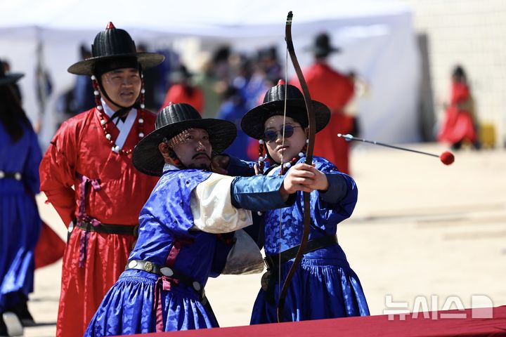 [서울=뉴시스] 김명년 기자 = 어린이날인 5일 오전 서울 종로구 경복궁 협생문에서 열린 갑사 취재 체험에서 전통 군복인 철릭을 입은 어린이가 활쏘기 체험을 하고 있다. 갑사 취재는 조선시대 궁궐 경비와 국왕 호위를 전담했던 중앙군 최정예 특수부대인 '갑사'를 선발하는 실기 평가다. 2026.05.05. kmn@newsis.com