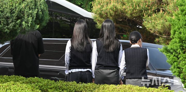 [광주=뉴시스] 이현행 기자 = 광주 도심에서 흉기 피습을 당해 숨진 고(故) A(17)양의 발인이 엄수된 7일 오전, 고인의 모교인 광산구 한 고등학교에서 학생들이 운구 차량을 향해 묵념하며 마지막 인사를 건네고 있다. 2026.05.07. lhh@newsis.com