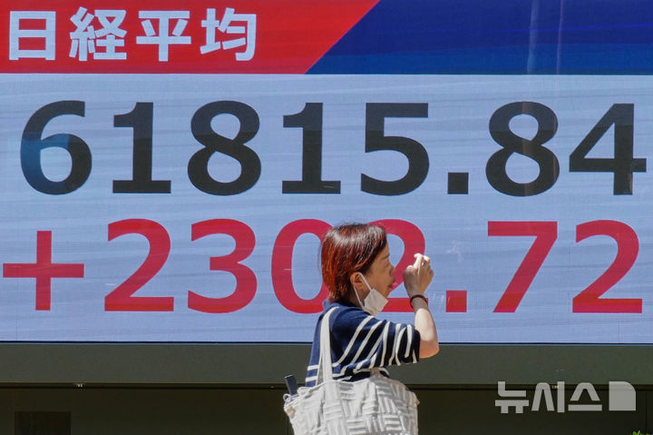 [도쿄=AP/뉴시스] 8일 일본 아사히신문 등 현지 언론에 따르면 일본 정부와 일본은행이 지난달 30일 외환시장에서 엔화를 사고 달러를 파는 방식의 환율 개입을 실시했다. 사진은 7일(현지시각) 일본 도쿄의 한 증권사에서 한 시민이 닛케이 지수가 표시된 전자 주가 게시판 앞을 걸어가고 있는 모습. 2026.05.08.