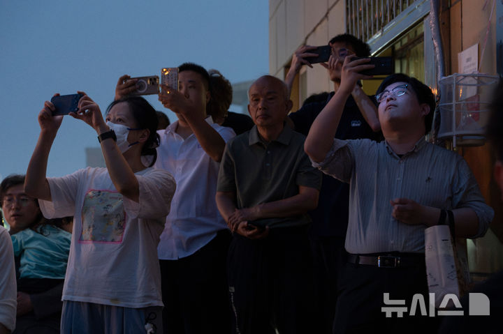 [베이징=AP/뉴시스] 도널드 트럼프 미국 대통령이 13일(현지 시간) 중국 베이징 수도 국제공항에 도착하자 시민들이 에어포스 원을 보기 위해 인근에서 대기하고 있다. 2026.05.14.