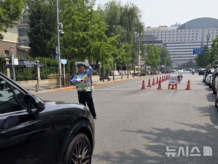 [베이징=뉴시스] 박정규 특파원 = 도널드 트럼프 미국 대통령의 방중 당일인 13일 오후 경비가 삼엄해진 가운데 베이징 차오양구의 주중 미국대사관에서 미국 대표단의 숙소로 추정되는 호텔로 향하는 도로의 차량 통행을 교통경찰이 통제하고 있다. 2026.05.13 photo@newsis.com