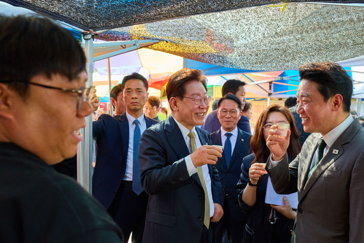 [서울=뉴시스] 최동준 기자 = 이재명 대통령이 14일 경기 성남 모란시장을 방문해 강훈식 비서실장과 시식을 하며 대화하고 있다. (사진=청와대 제공) 2026.05.14. photo@newsis.com *재판매 및 DB 금지