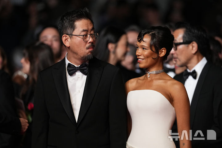 [칸=AP/뉴시스] 영화 '호프'의 나홍진(왼쪽) 감독이 배우 테일러 러셀과 함께 17일(현지 시간) 프랑스 칸에서 열린 '제79회 칸 국제영화제' 영화 '호프' 시사회에 참석해 포토 타임을 갖고 있다. 2026.05.18.