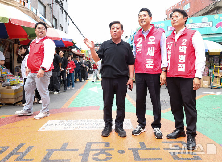 [서울=뉴시스] 최진석 기자 = 오세훈 국민의힘 서울시장 후보가 19일 서울 종로구 창신동 문구완구거리에서 오세훈과 함께 걸어요를 하며 상인의 거리 설명을 듣고 있다. 2026.05.19. myjs@newsis.com