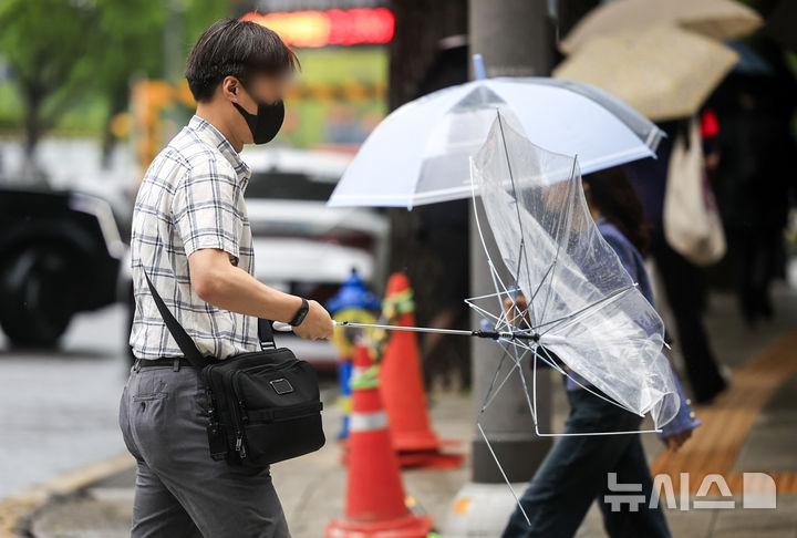 [서울=뉴시스] 정병혁 기자 = 비가 내리고 있는 20일 서울 종로구 정부서울청사 인근에서 우산을 쓴 시민들이 이동하고 있다. 2026.05.20. jhope@newsis.com