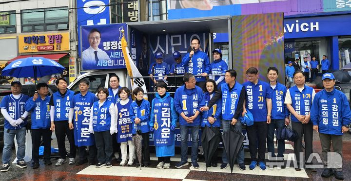 [충주=뉴시스] 이병찬 기자 = 맹정섭 충주시장 후보 등 더불어민주당 충북 충주 지방선거 후보들이 21일 맹 후보 선거사무소 앞 거리에서 출정식을 하고 있다.(사진=맹 후보 제공)2026.05.21.photo@newsis.com