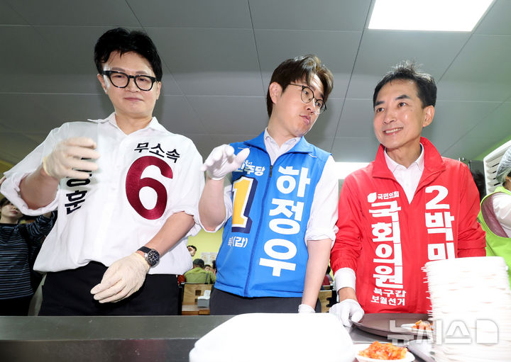 [부산=뉴시스] 김진아 기자 = 제9회 전국동시지방선거 및 국회의원 재·보궐선거의 공식 선거운동이 시작된 21일 부산 북구갑 국회의원 보궐선거 국민의힘 박민식(오른쪽부터), 더불어민주당 하정우, 무소속 한동훈 후보가 부산 북구 남산정복지관에서 열린 콩국수 나눔행사에서 콩국수를 기다리고 있다. 2026.05.21. bluesoda@newsis.com