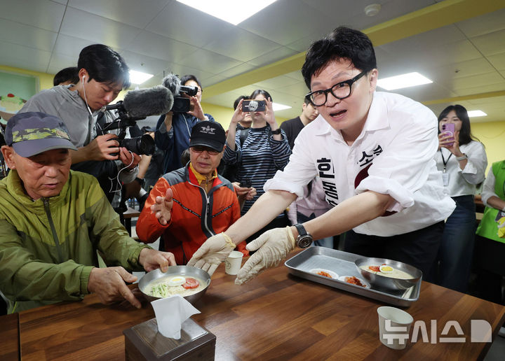[부산=뉴시스] 김진아 기자 = 제9회 전국동시지방선거 및 국회의원 재·보궐선거의 공식 선거운동이 시작된 21일 한동훈 무소속 부산 북구갑 국회의원 보궐선거 후보가 부산 북구 남산정복지관에서 열린 콩국수 나눔행사에서 콩국수를 나르고 있다. 2026.05.21. bluesoda@newsis.com