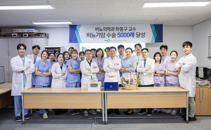 [부산=뉴시스] 부산대병원 비뇨의학과 하홍구 교수(앞줄 왼쪽 여섯번째)가 비뇨기암 수술 5000례 달성을 기념해 의료진과 기념촬영을 하고 있다. (사진=부산대병원 제공) 2026.05.22. photo@newsis.com *재판매 및 DB 금지