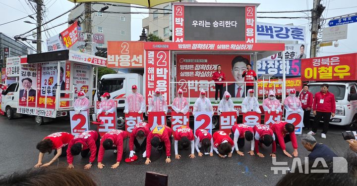 [포항=뉴시스] 송종욱 기자 = 27일 경북 포항시 북구 흥해읍 흥해시장 입구인 오터리에서 지원 유세한 국민의힘 나경원 의원과 박용선 시장 후보, 시도 의원 후보가 지지를 호소하며 큰절을 하고 있다. 2026.05.27. sjw@newsis.com