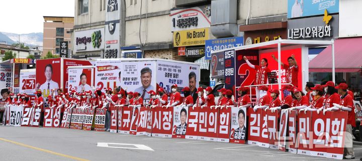 [제천=뉴시스] 이병찬 기자 = 27일 충북 제천 도심 거리에서 열린 국민의힘 후보자 합동 유세에서 연단에 오른 김창규 제천시장 후보와 배우자가 율동을 선보이고 있다.2026.05.27.bclee@newsis.com 