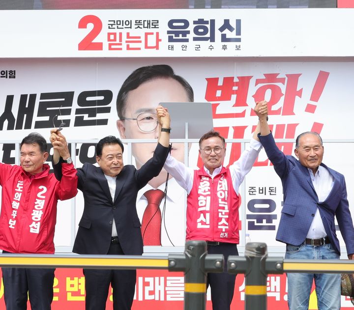 [태안=뉴시스] 28일 충남 태안 신터미널 앞에서 국민의힘 윤희신 태안군수 후보가 같은당 도의원 후보 등과 손을 잡고 지지자들에게 인사하고 있다. (사진=윤희신 후보 캠프 제공) 2026.05.28. photo@newsis.com *재판매 및 DB 금지