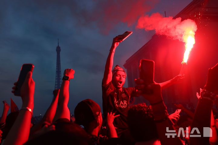 [파리=AP/뉴시스] 지난달 30일(현지 시간) 프랑스 파리에서 프로축구팀 파리 생제르맹(PSG)이 2025~2026 유럽축구연맹(UEFA) 챔피언스리그에서 우승하자 팬들이 환호하고 있다. 2026.06.01.