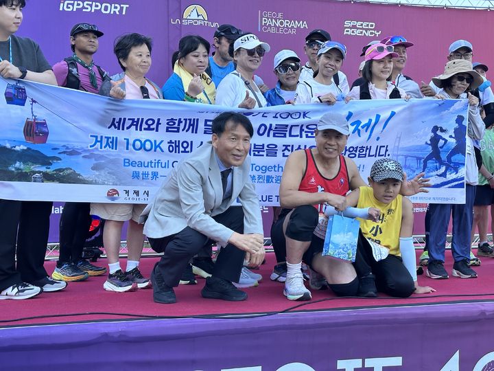[거제=뉴시스] 신정철 기자= 자폐 스펙트럼을 가지고 있지만, 무엇보다 달리기를 좋아하는 대만 소년 호포언(HO PO EN·9) 군이 지난 30일 '거제100K 트레일러닝대회'에 참가해 거제의 아름다운 산과 바다를 배경으로 펼쳐진 코스를 달리며 스포츠와 관광을 함께 즐겼다. 사진은 대만 타이베이에서 참가한 호천정(HO CHEN JUNG) 씨 가족(사진 앞줄 오른쪽) 대회 참가 기념사진.(사진=거제시 제공).2026.06.01. photo@newsis.com *재판매 및 DB 금지