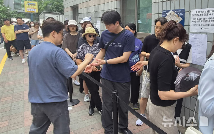[서울=뉴시스] 조수원 기자=제9회 전국동시지방선거일인 3일 서울 송파구 가락2동 제3투표소에서 투표용지 부족으로 유권자들이 길게 줄지어 서서 대기표를 받고 있다. 2026.06.03.tide1@newsis.com